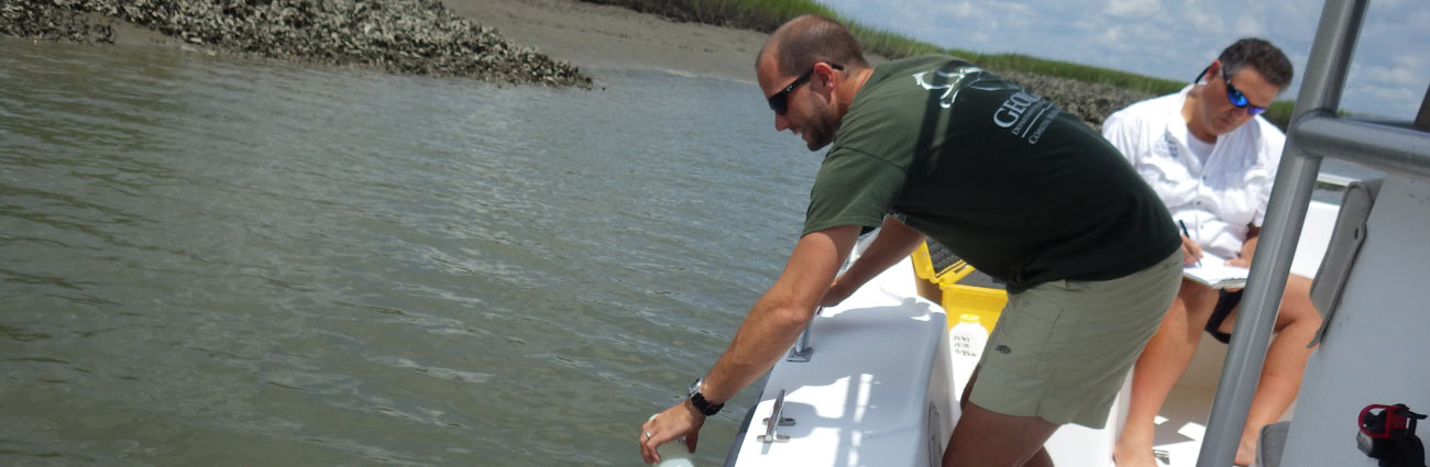 Man getting a sample of water.